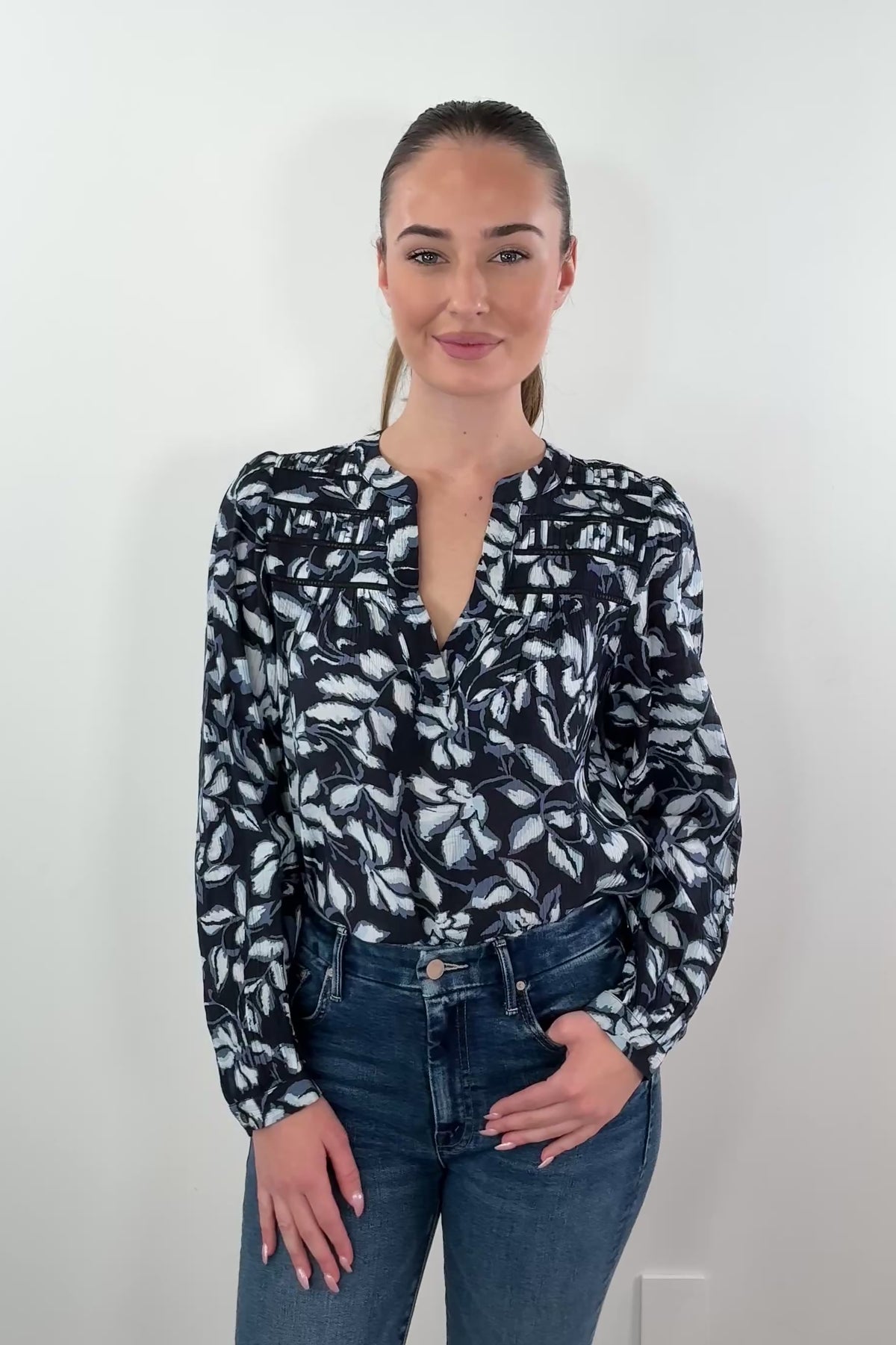 video of woman wearing a black and white printed v neck