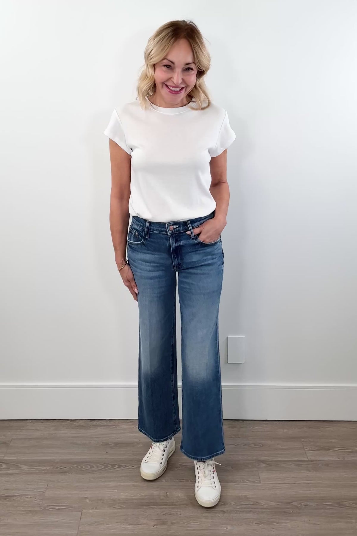 video of woman wearing washed blue mid rise denim