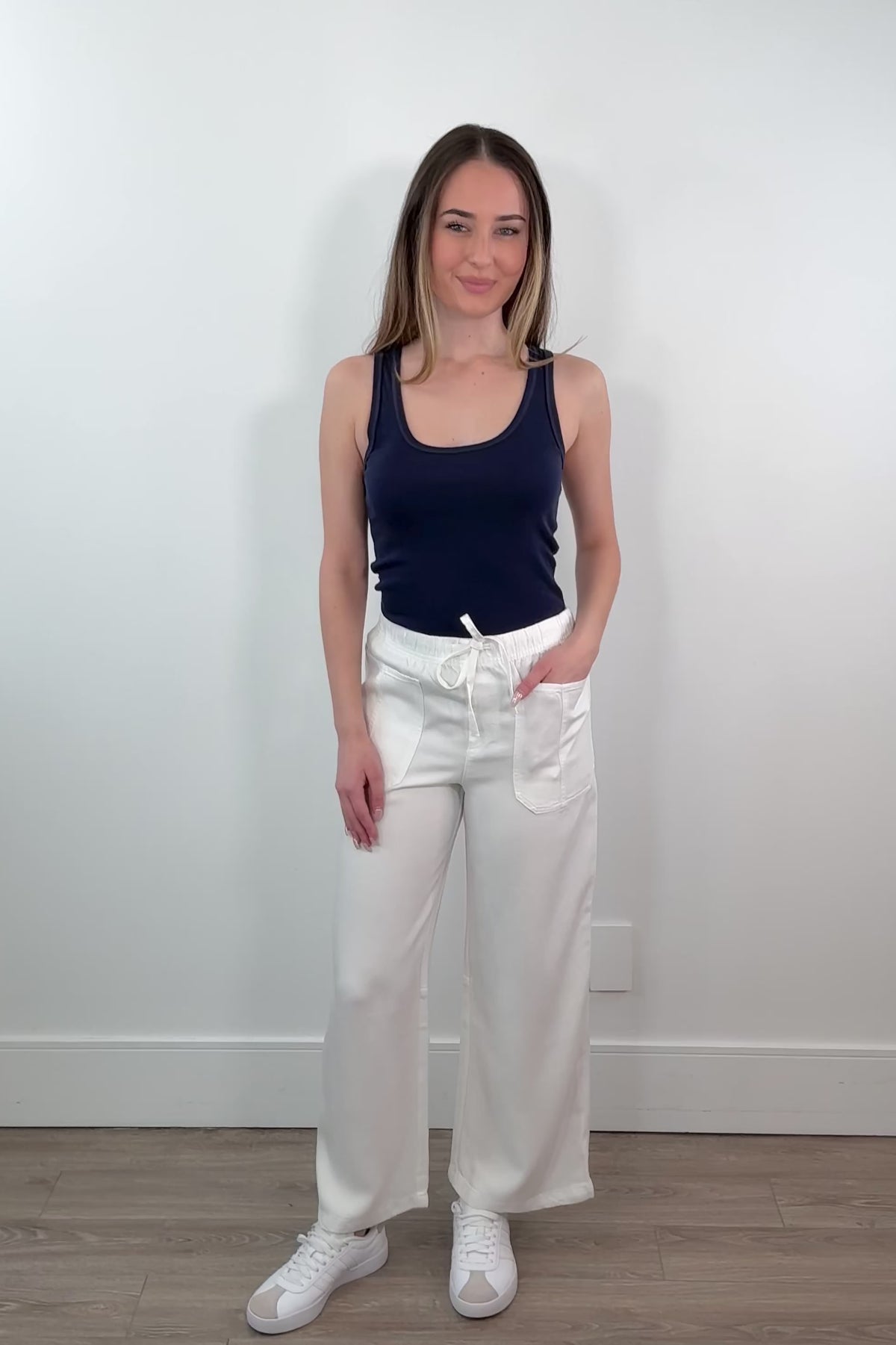 video of a woman wearing a white tencel denim pants
