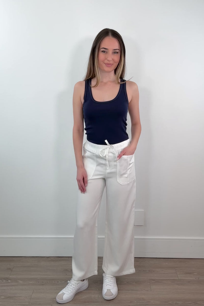 video of a woman wearing a white tencel denim pants