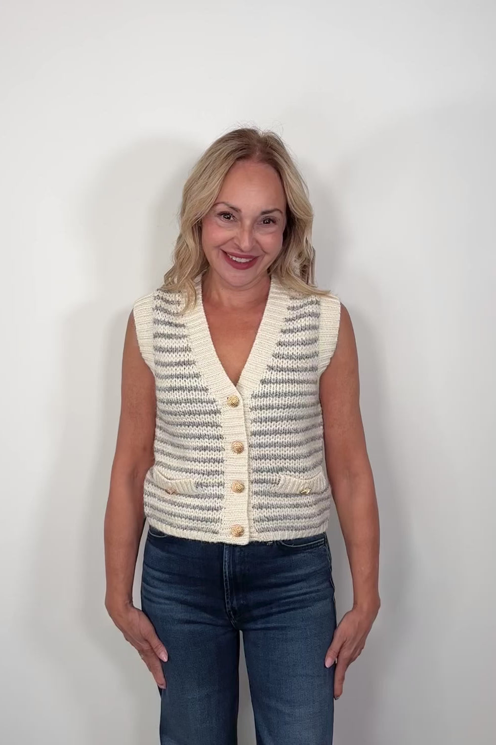 Video of a woman wearing a knitted striped vest