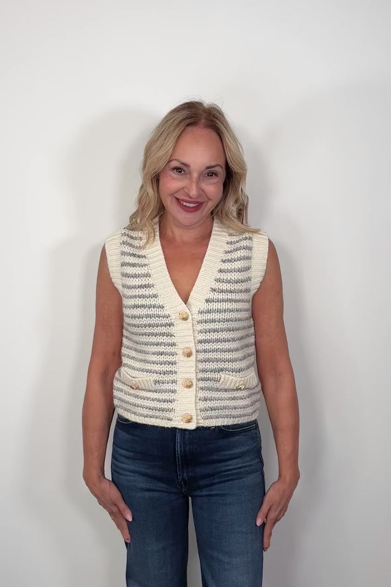 Video of a woman wearing a knitted striped vest