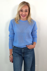 video of a woman wearing a blue open knit cashmere sweater 