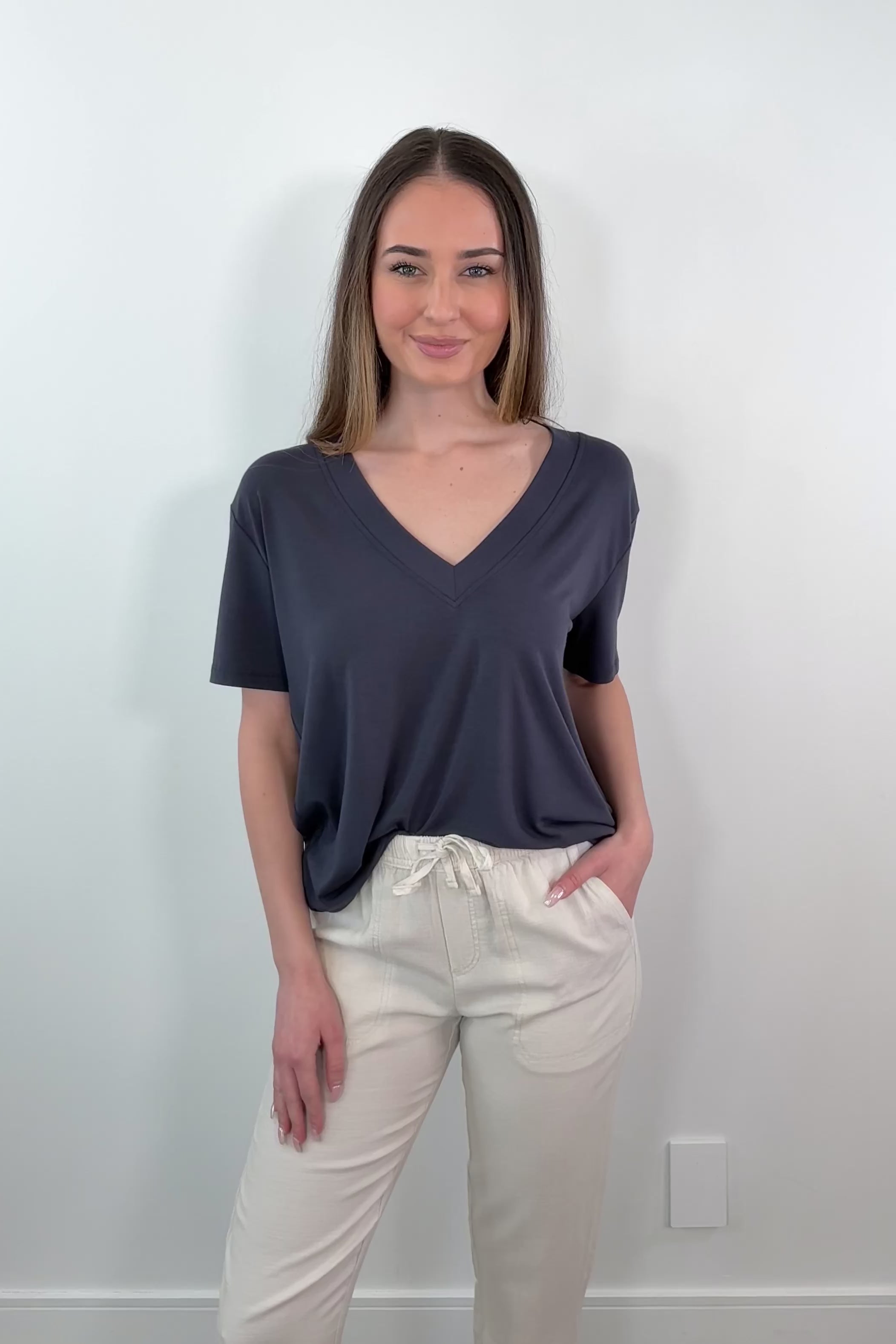 video of a woman wearing a navy V-neck t-shirt