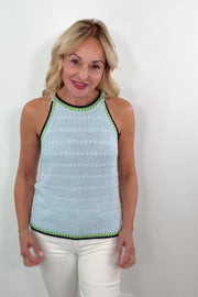 video of a woman wearing a light blue knitted tank with black and green stitching