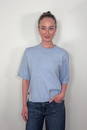 Video of woman wearing a light blue half sleeve sweater