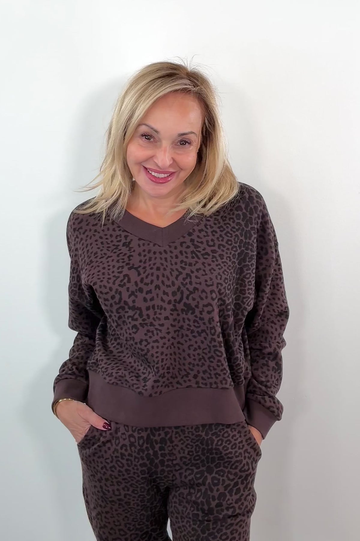video of a woman wearing a brown leopard print sweatshirt