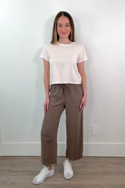 video of a woman wearing brown ankle length wide leg pants