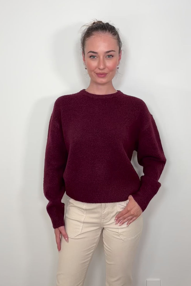 Video of woman wearing a wine coloured crew-neck sweater 