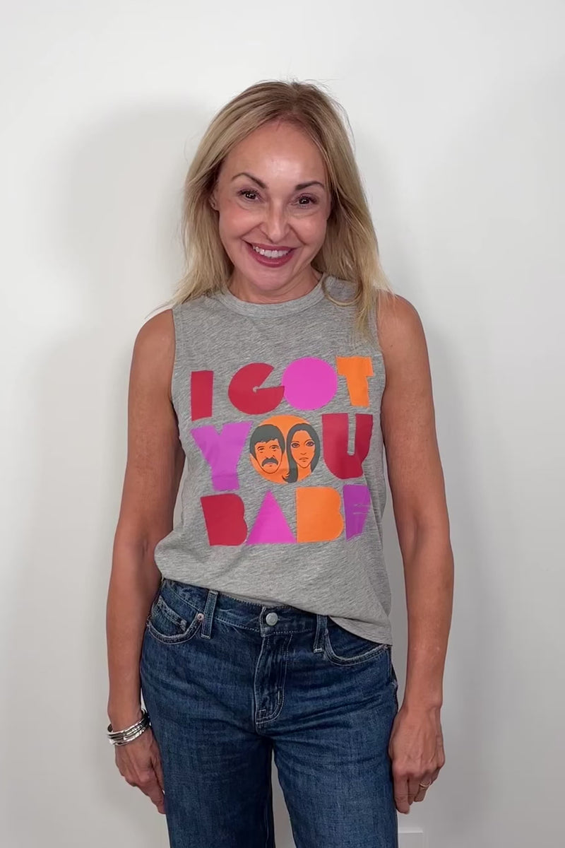 Video of woman wearing a gray sleeveless tee with “I got you babe” graphic words printed turning around to show the back.