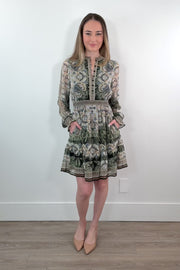 video of a woman wearing an ivory, green and black short A-line long sleeve dress