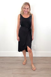 Video of woman wearing a black midi dress with bow detailing n the side