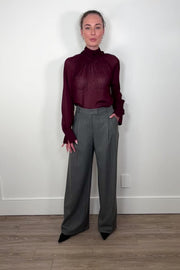 Video of woman wearing a gray pinstripe wide leg pant with a burgundy line down the leg