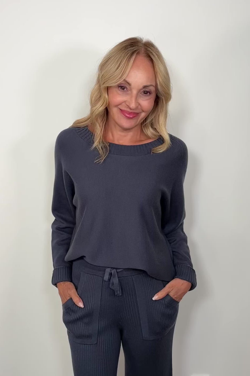 Video of woman wearing a Cashmere blend blue pullover ribbed sweater turning around to show the back