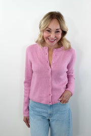 video of woman wearing pink ribbed cardigan