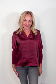 Video of a woman wearing a wine red mix satin lingerie sleeve top