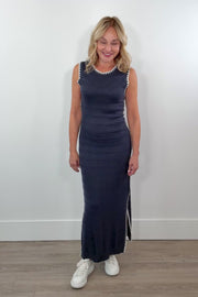 video of woman wearing a knit dark blue dress with white detail