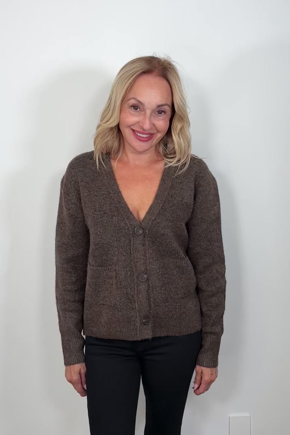 Video of a woman wearing Brown cardigan with front pockets 