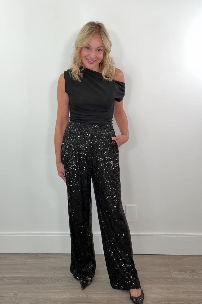 video of a woman wearing black sequin pants