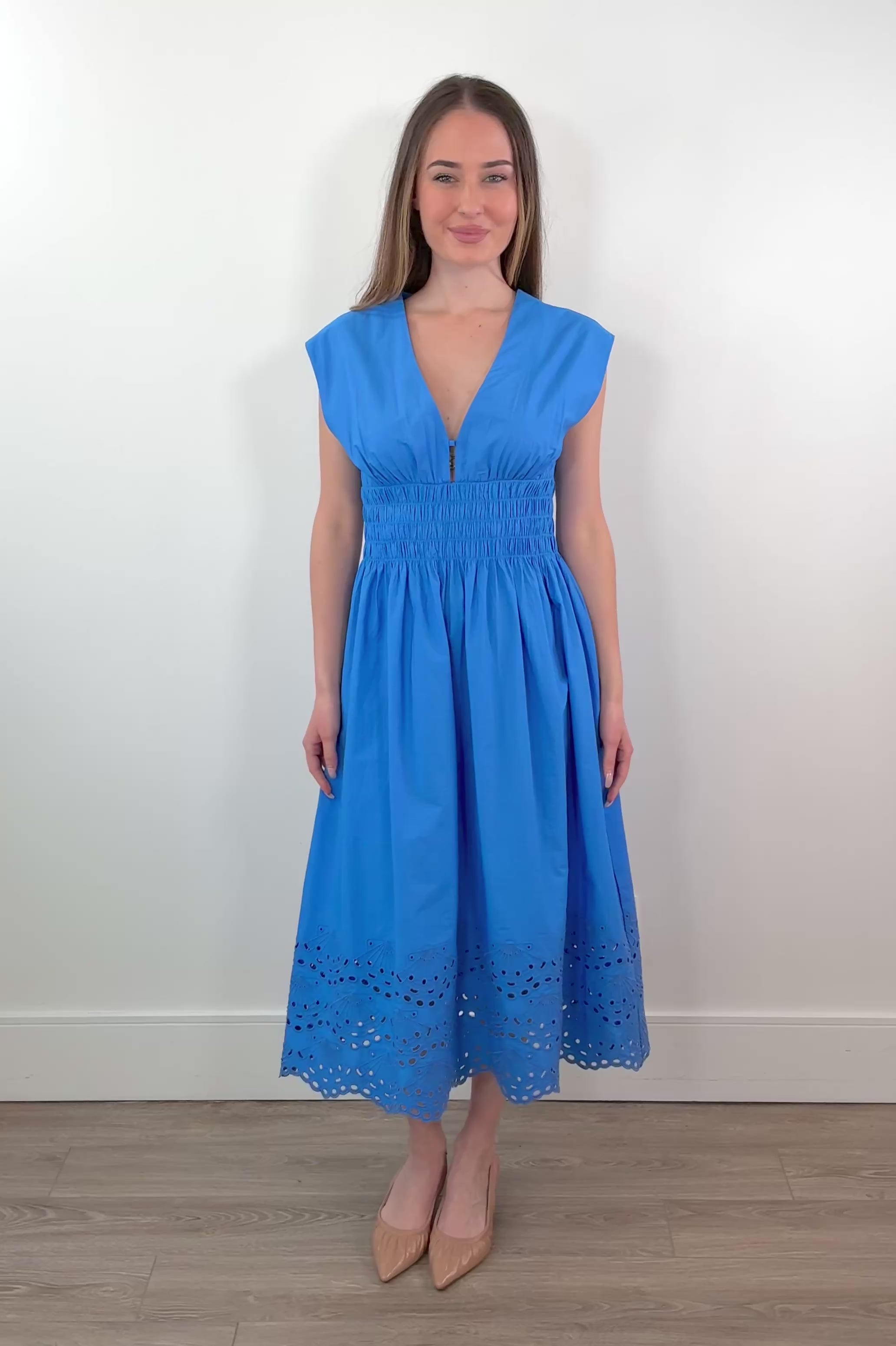 Video of woman wearing a midi dress in light blue