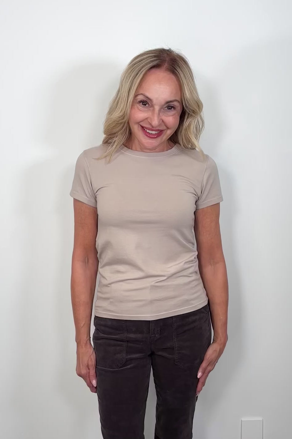 video of a woman wearing a plain beige short sleeve tee