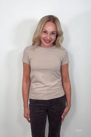 video of a woman wearing a plain beige short sleeve tee