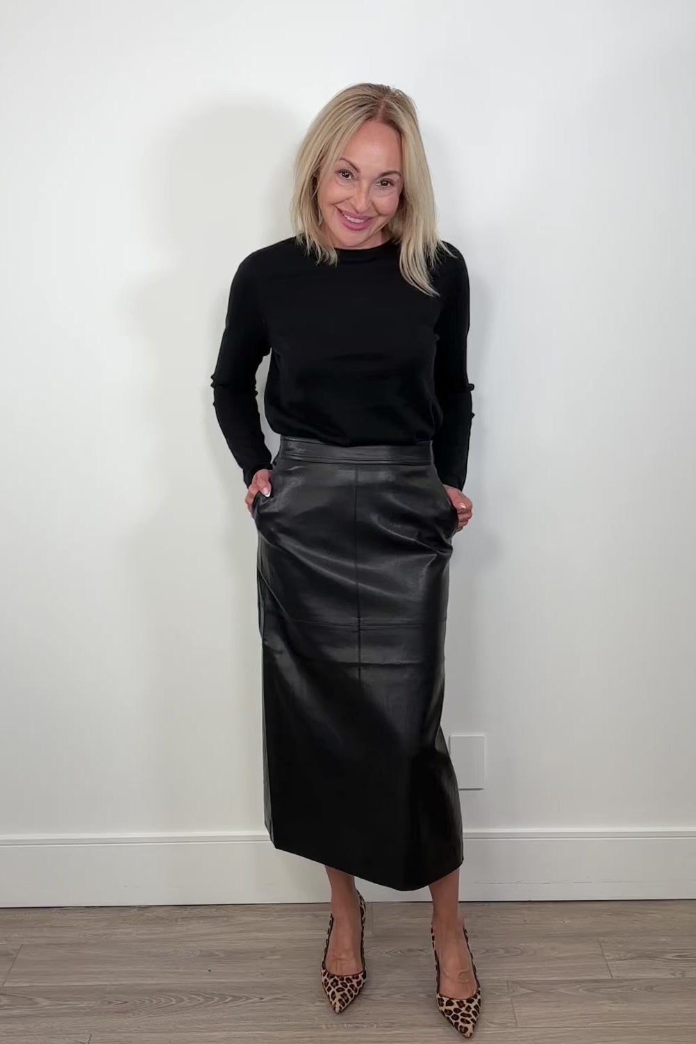 Video of a person wearing a black leader skirt and a long sleeve black top