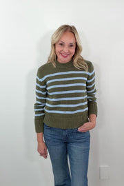 video of a woman wearing a green and blue striped sweater 