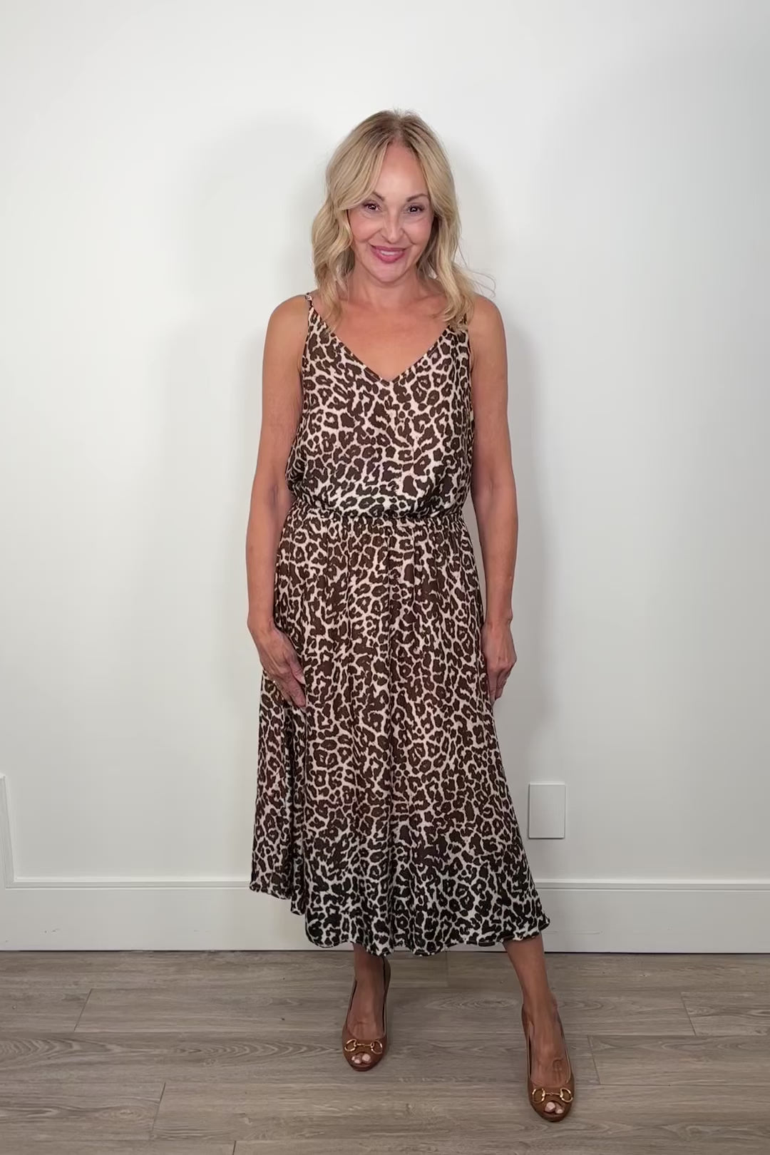 video of a woman wearing a gathered leopard print long skirt paired with a matching top