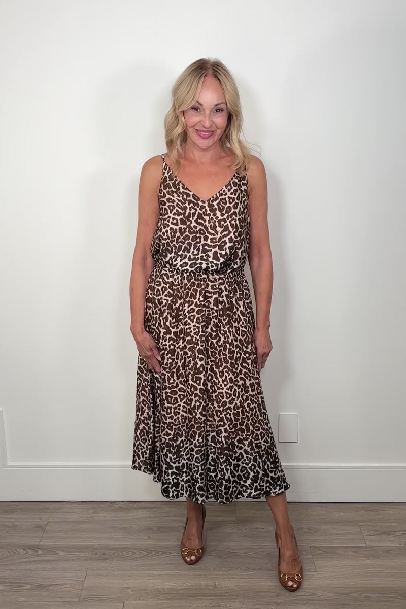 video of a woman wearing a gathered leopard print long skirt paired with a matching top