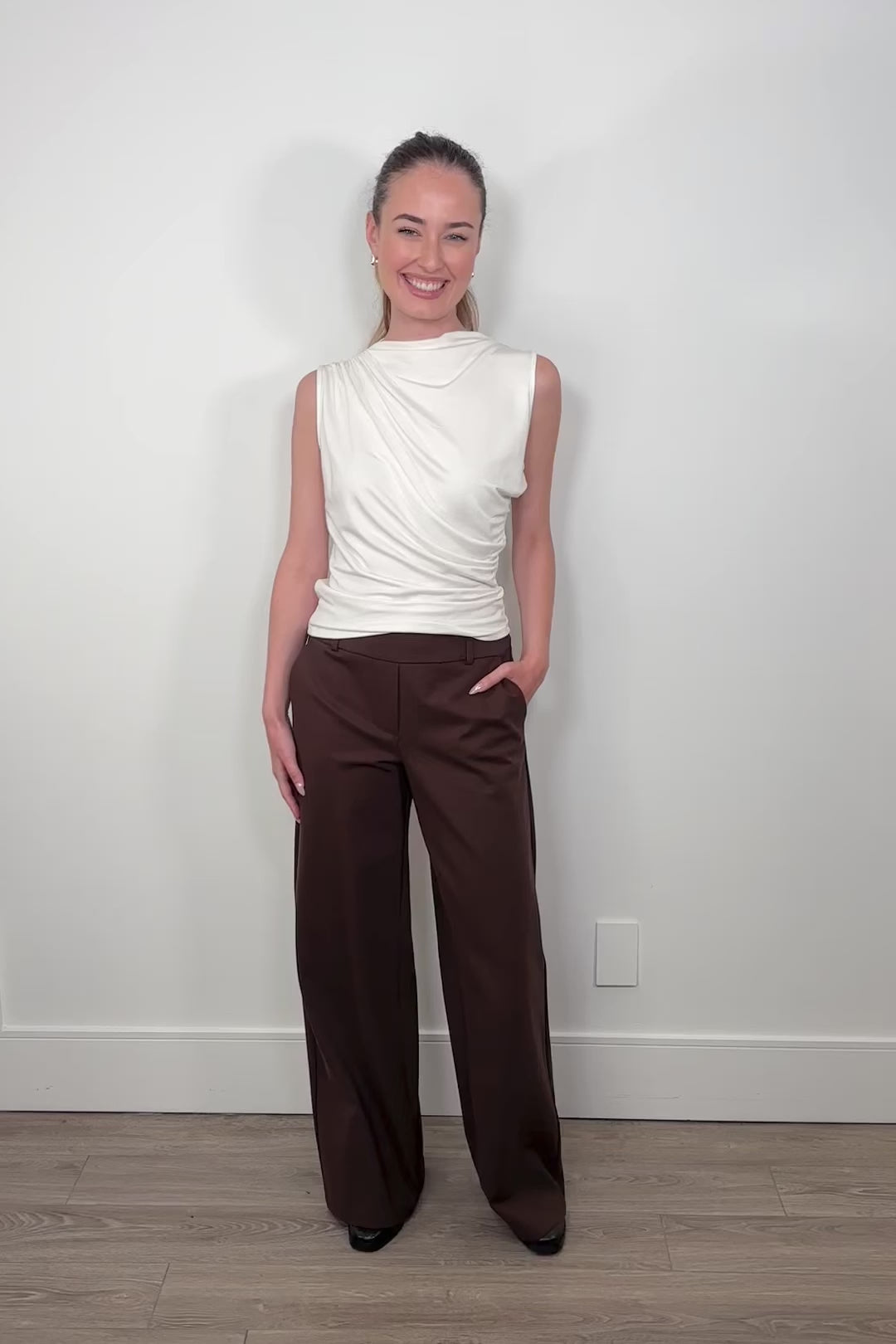 Video of woman wearing a brown wide leg ponte pant