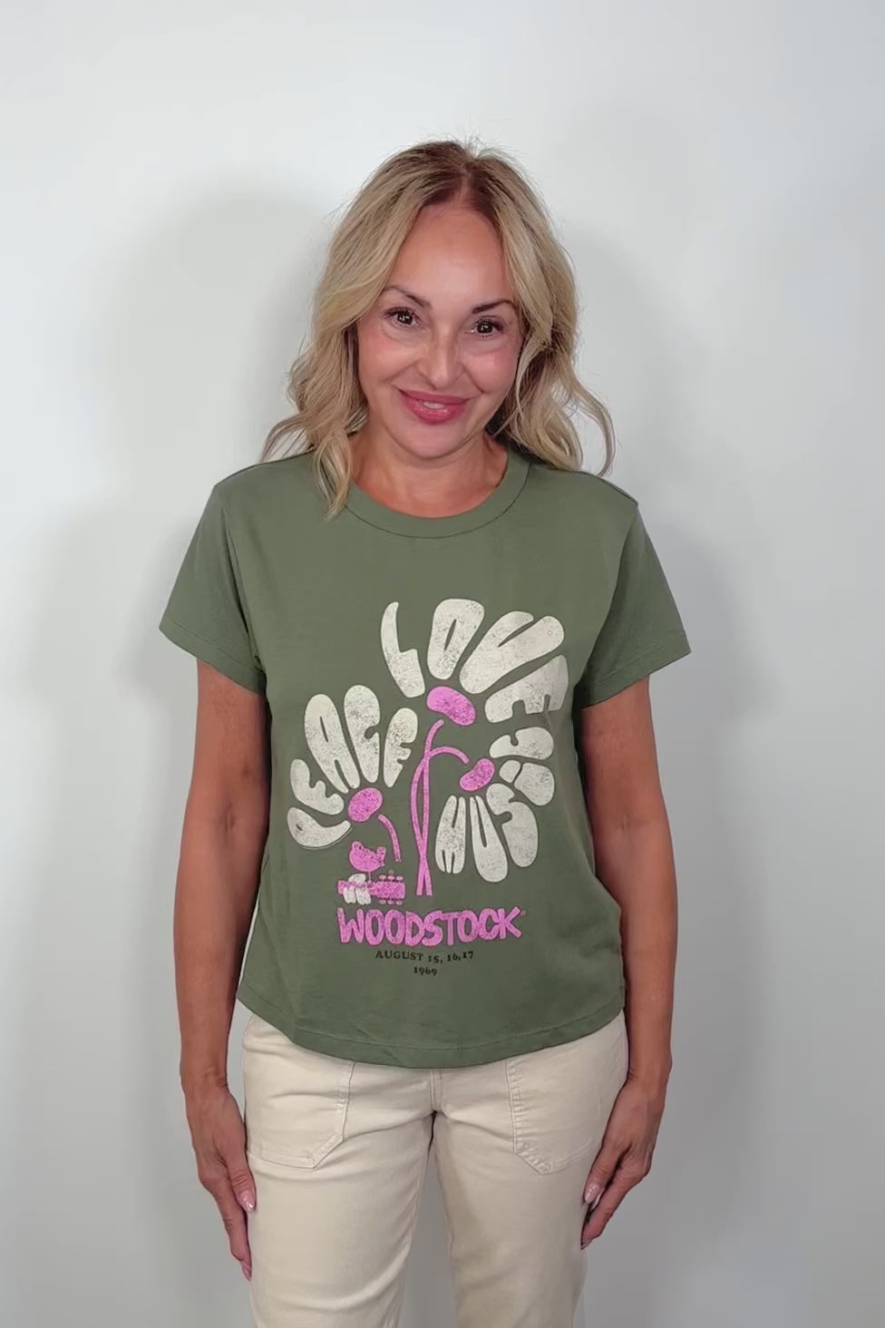 Video of a woman wearing a woodstok-festival printed tee