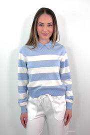 video of a woman wearing a blue and white striped polo sweater