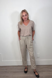 Video of woman wearing a cool beige straight pant with detailing on the side