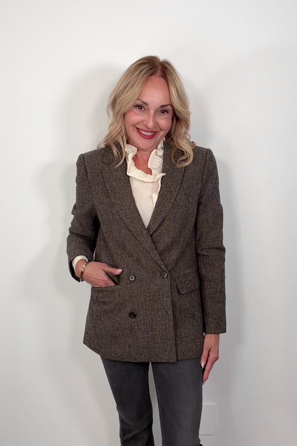 Video of a woman wearing cool-toned brown herringbone blazer
