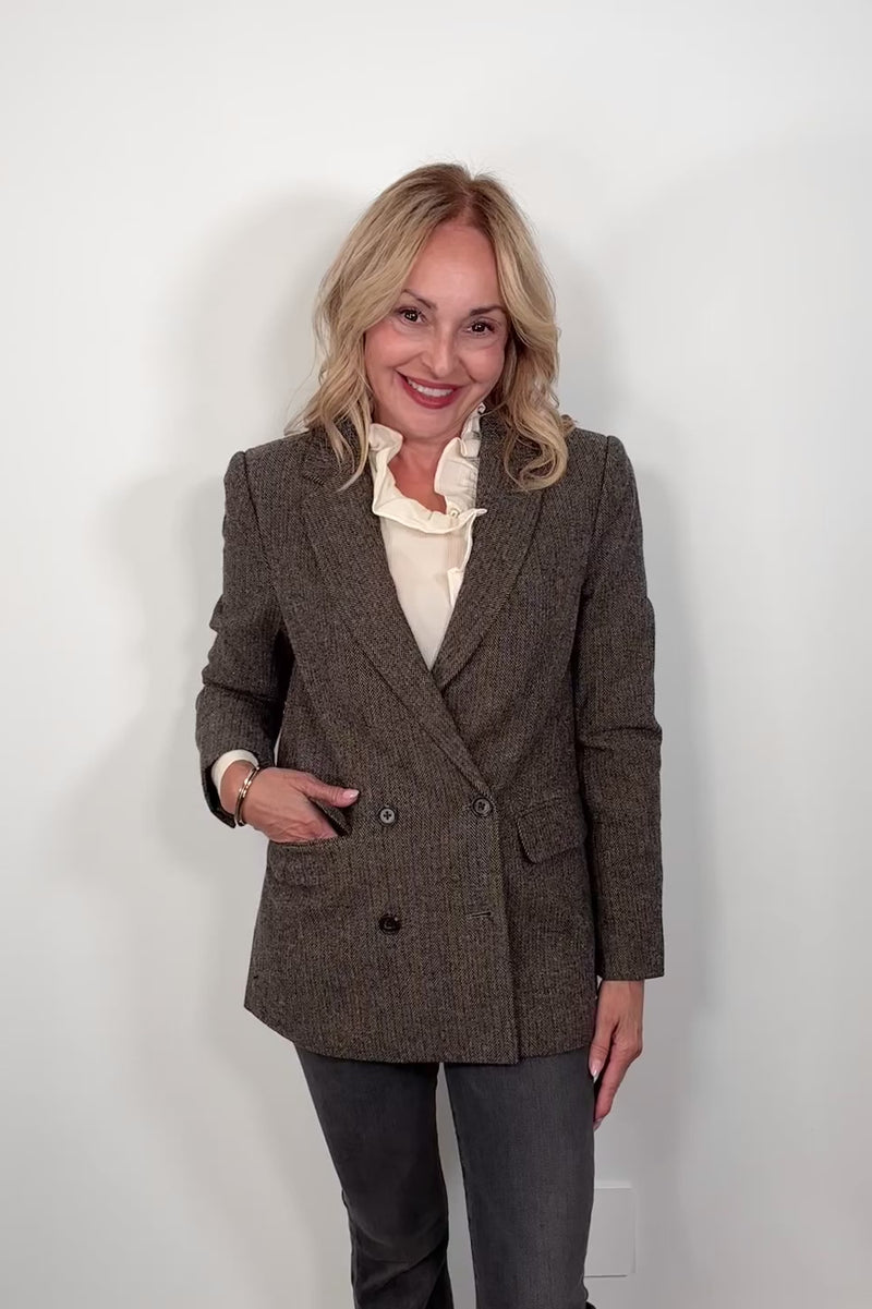 Video of a woman wearing cool-toned brown herringbone blazer