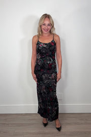 Video of a woman wearing a floral maxi fitted dress with velvet detailing