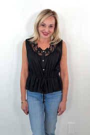 Video of Woman wearing a sleeveless top with neckline detail in black