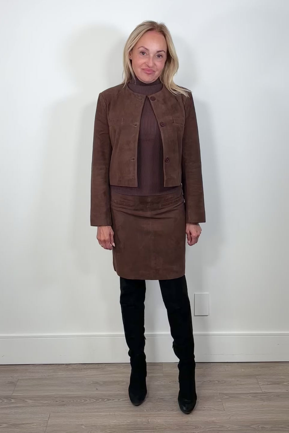 Video of a woman wearing a brown short suede leather skirt