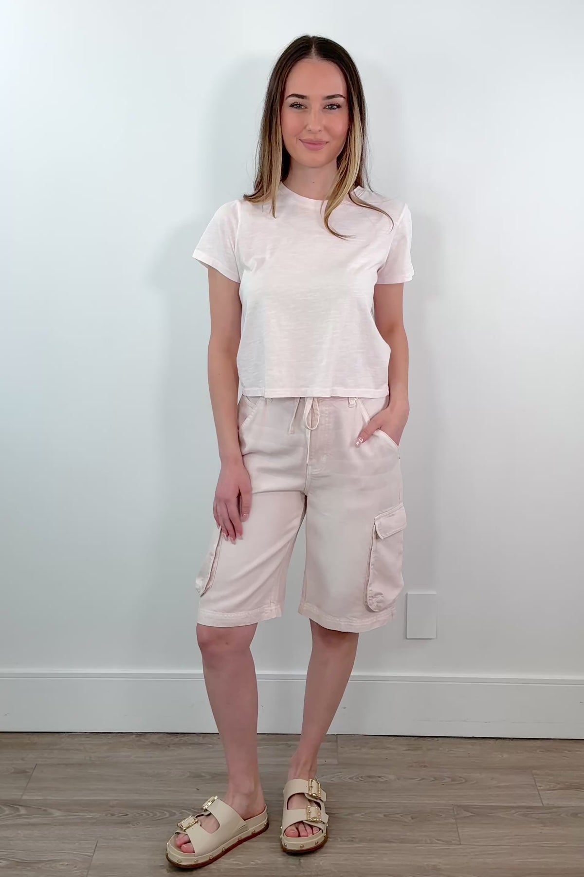 video of a woman wearing light pink cargo shorts