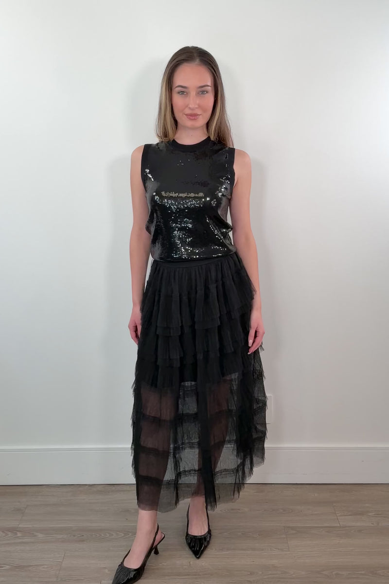 video of a woman wearing a black tiered tulle midi skirt