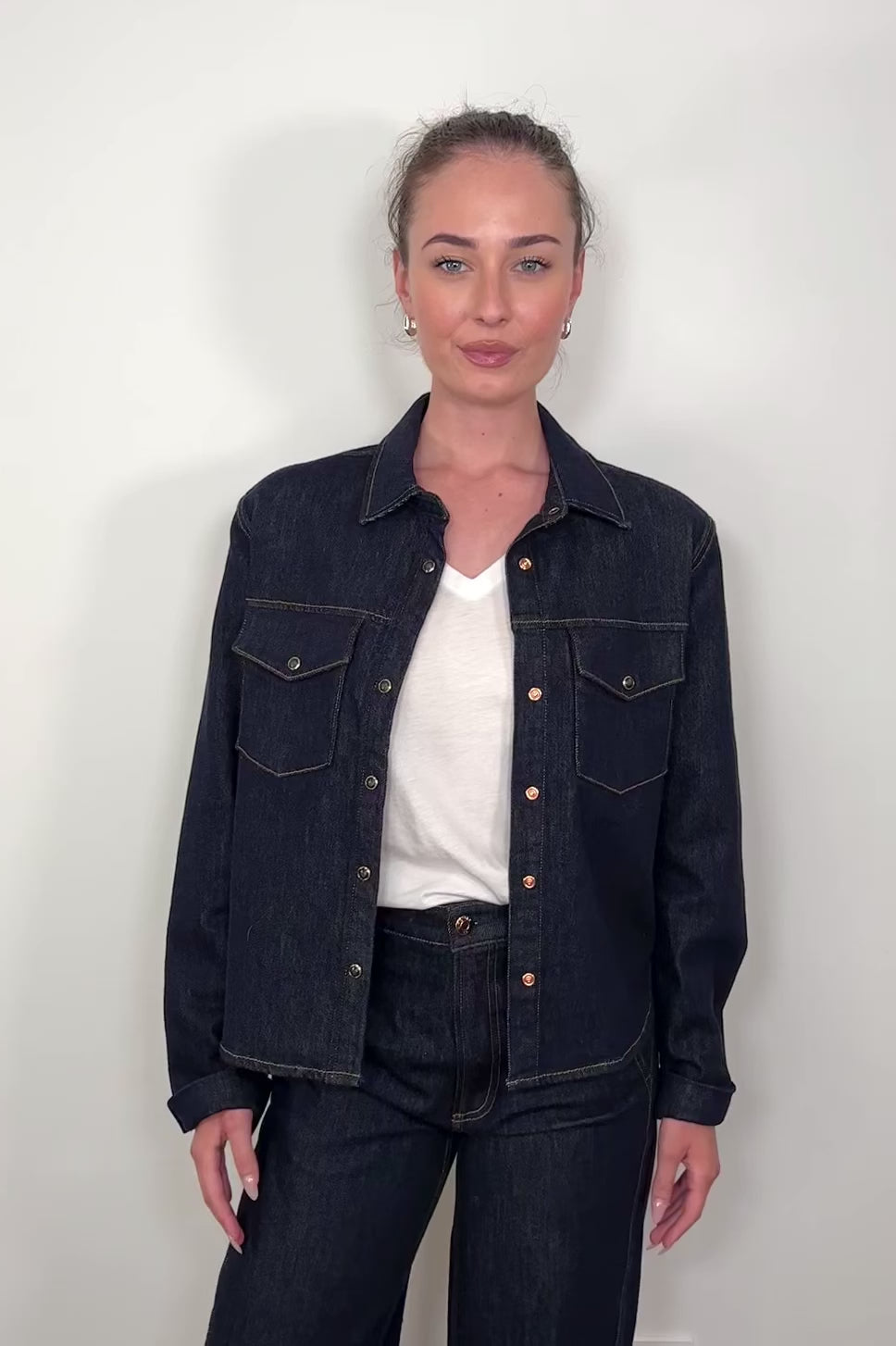 video of a woman wearing dark wash denim jacket