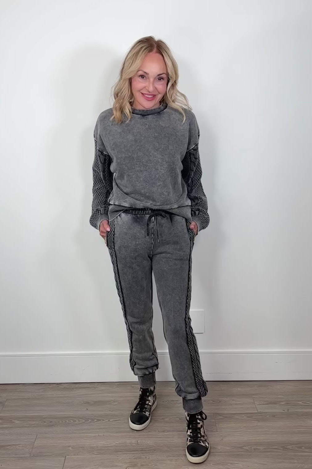 Video of a woman wearing gray cuffed sweatpants 