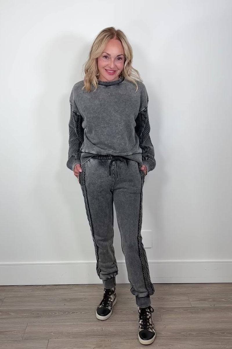 Video of a woman wearing gray cuffed sweatpants 