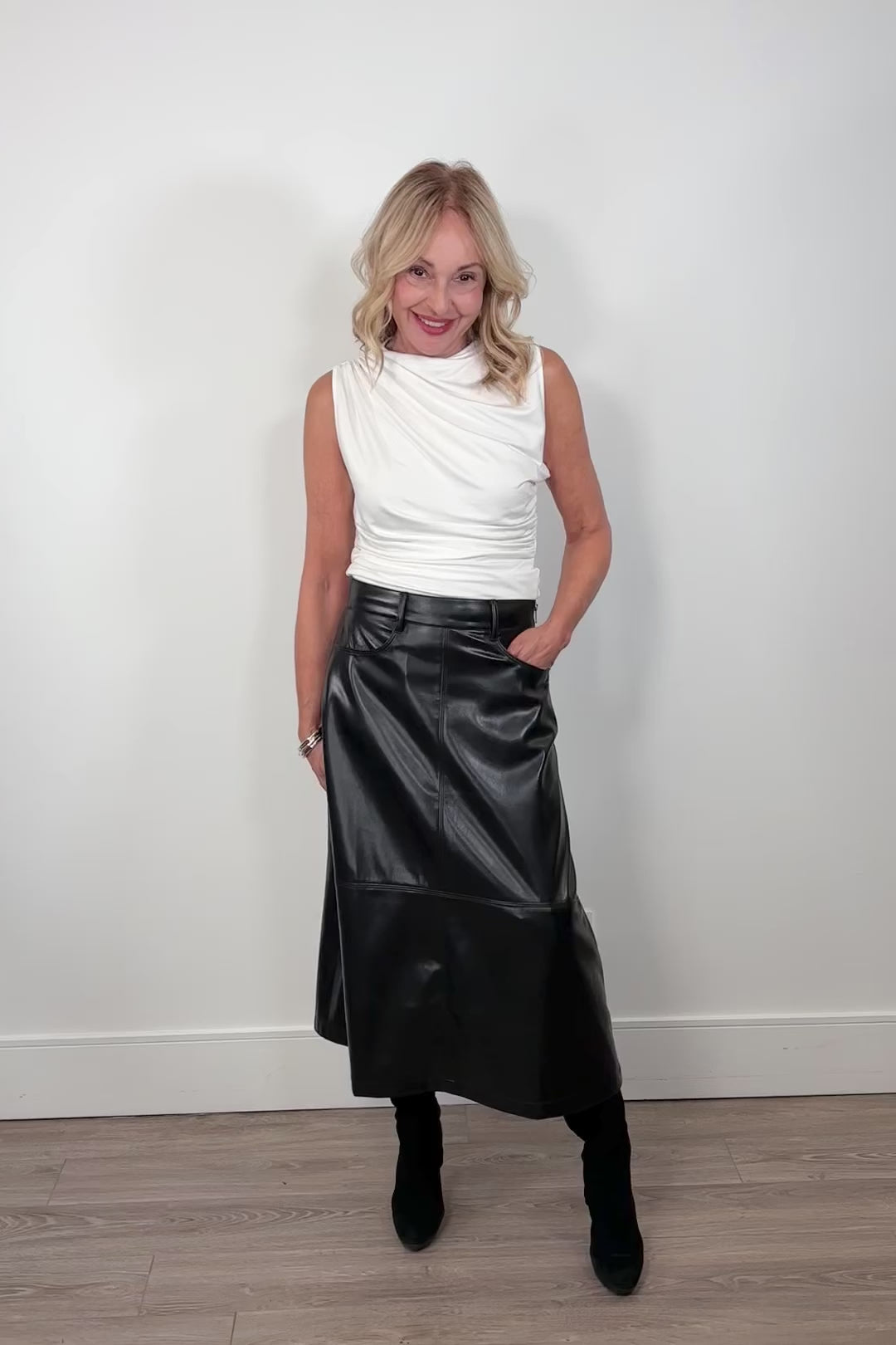 video of a woman wearing a black faux leather skirt