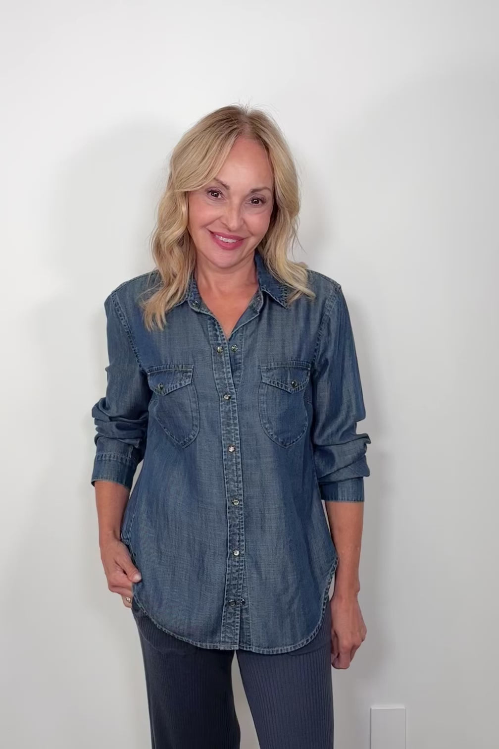 Video of woman wearing a western snap blue shirt 