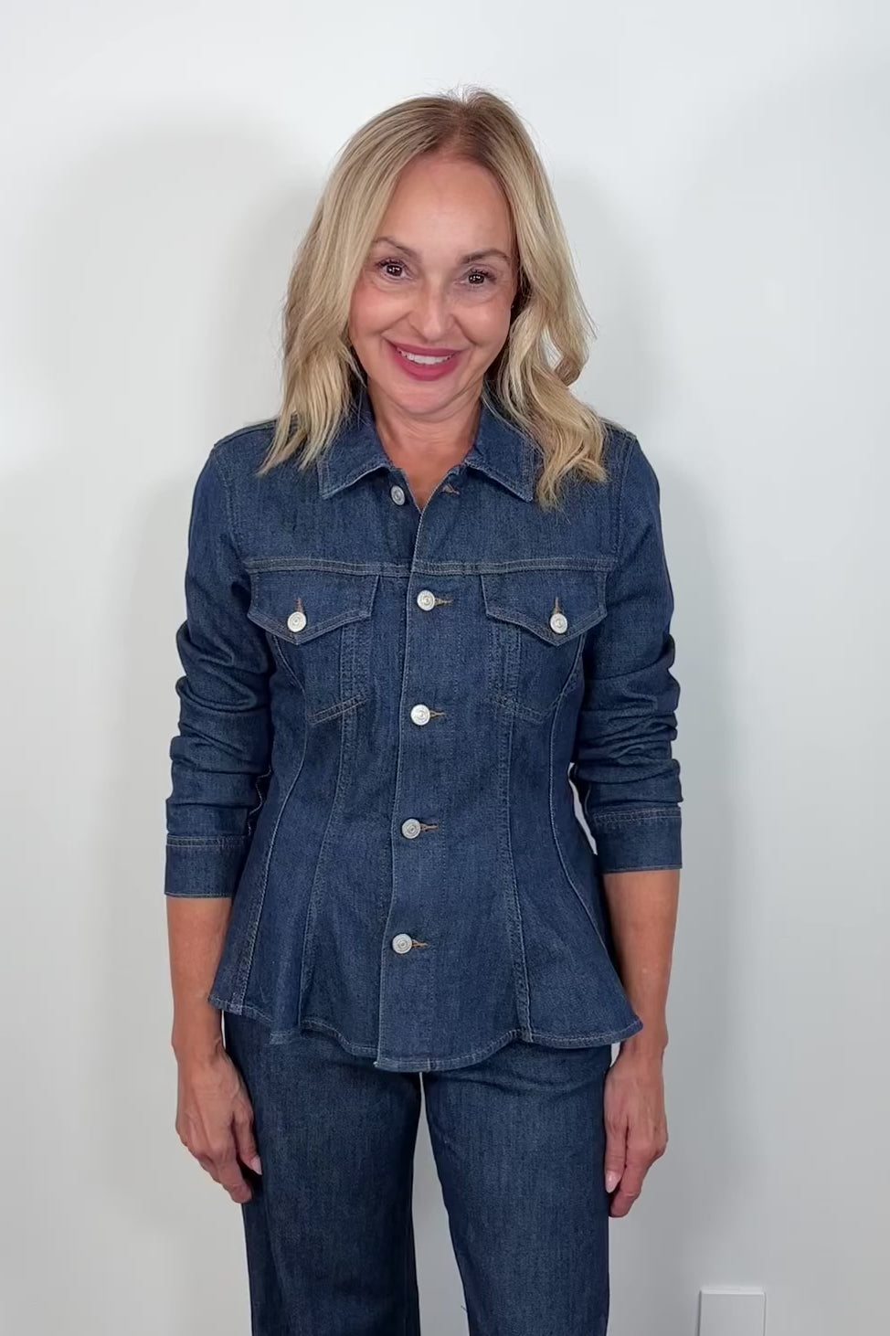 Video of a woman wearing a fitted denim jacket