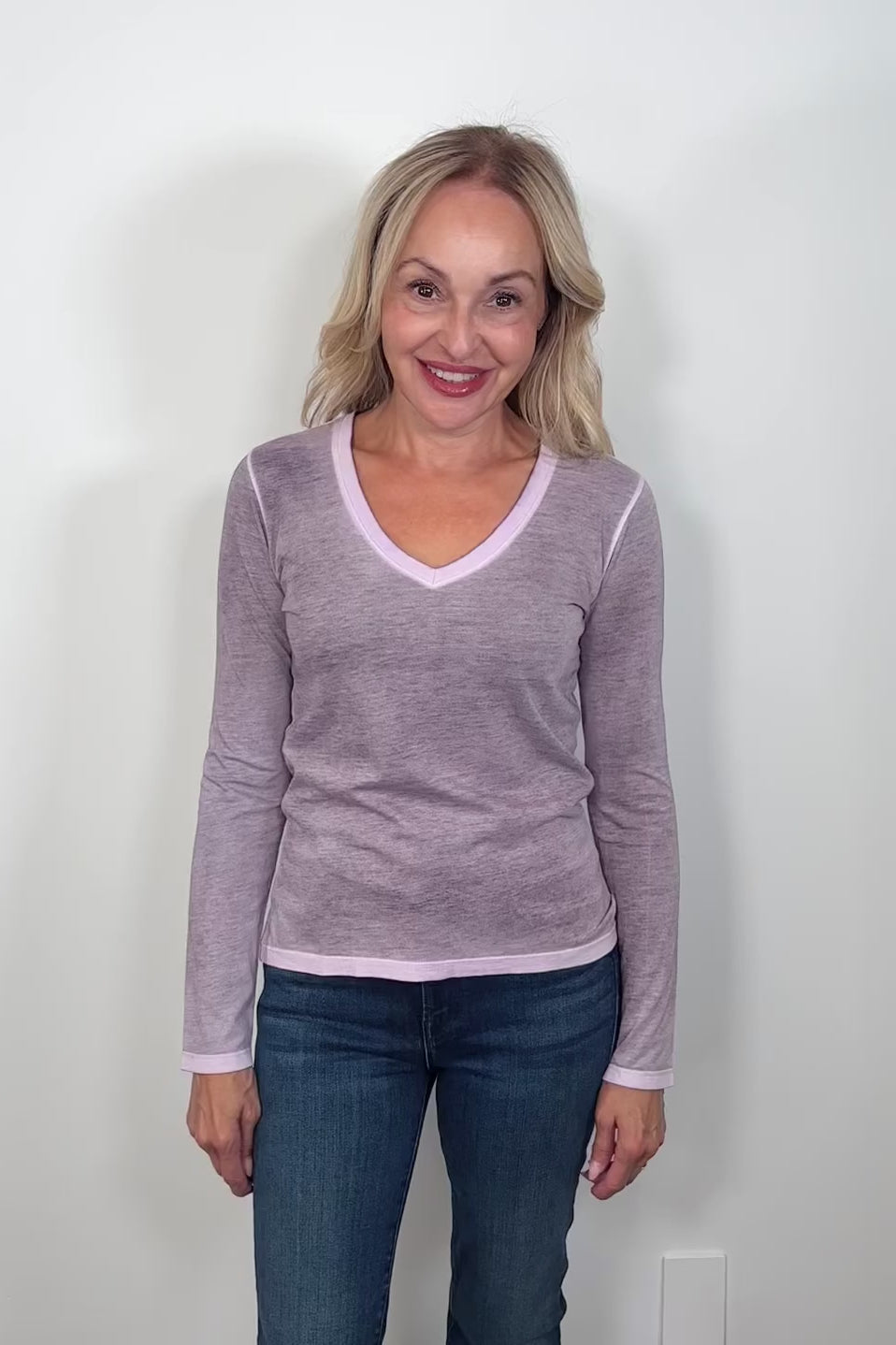 Video of a woman wearing a long-sleeve dark purple rev spray v-neck tee