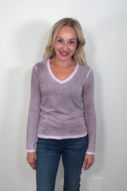 Video of a woman wearing a long-sleeve dark purple rev spray v-neck tee