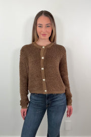 video of a woman wearing a warm brown textured cardigan